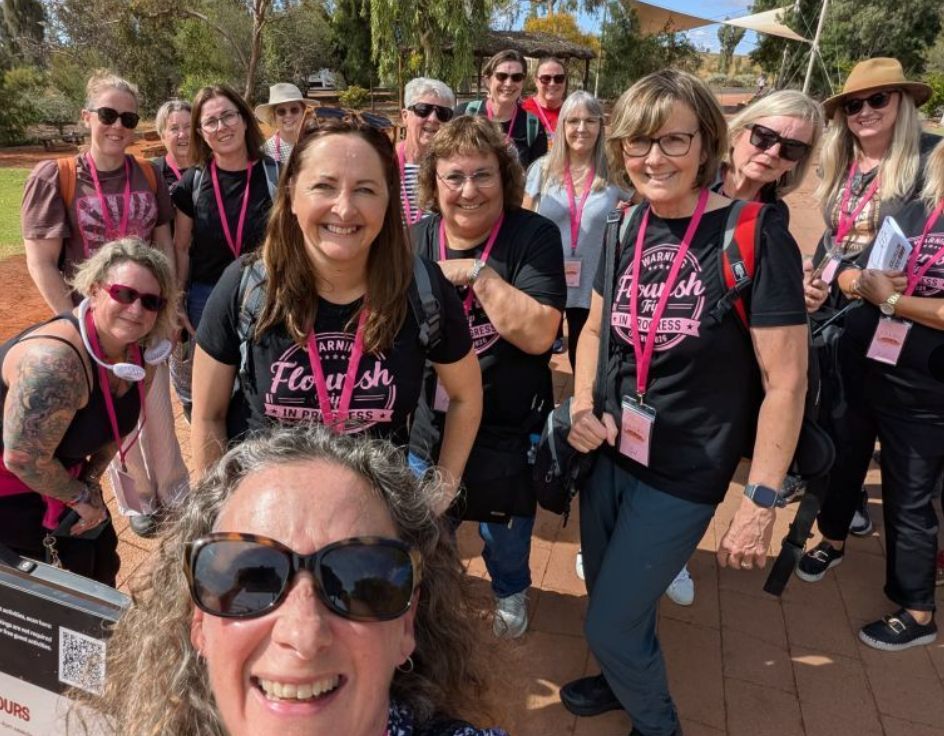 Alison Plath with a group of women on a Flourish Experiences trip at Uluru